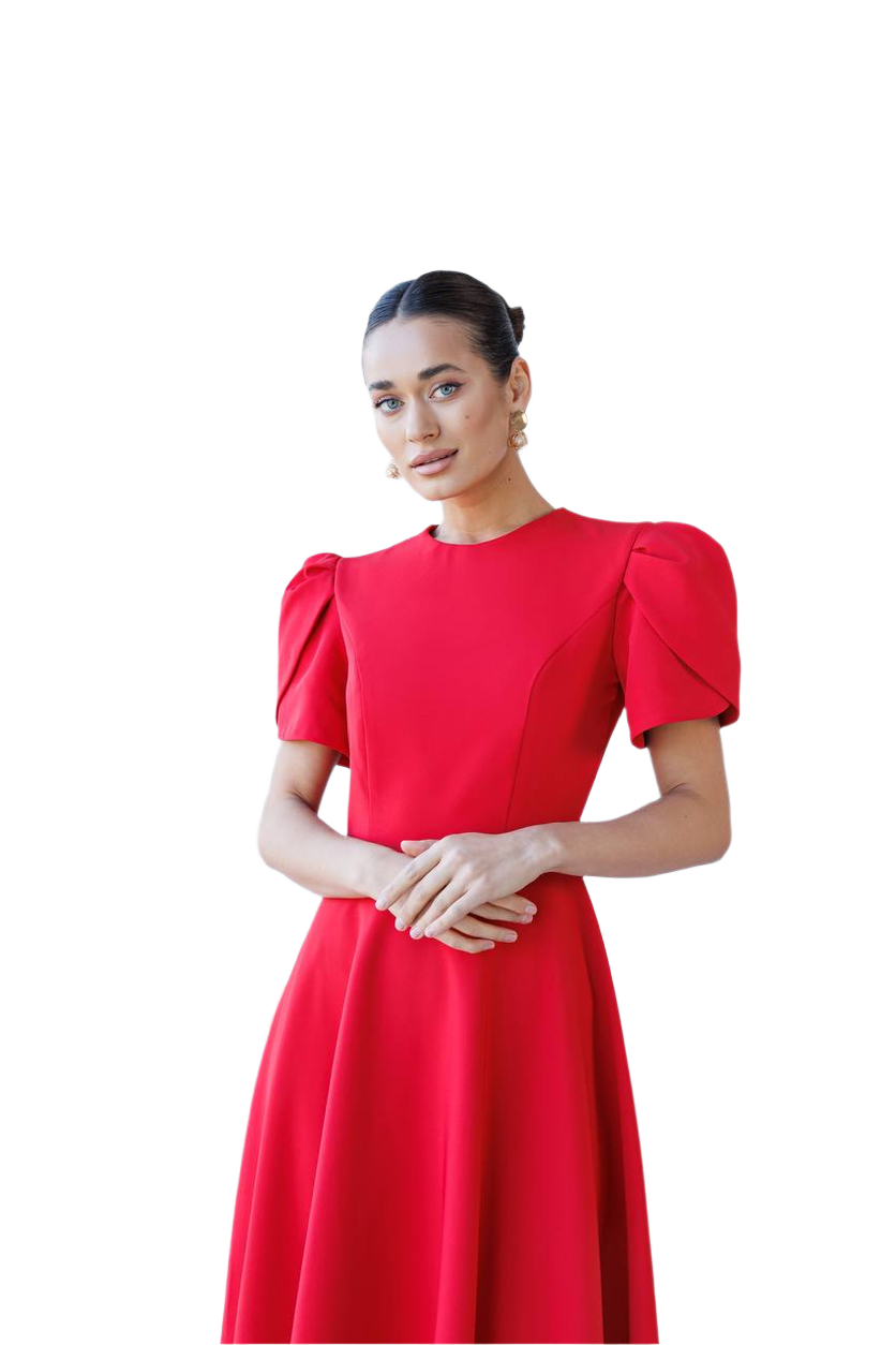 Woman wearing a red dress with puff sleeves on a white background