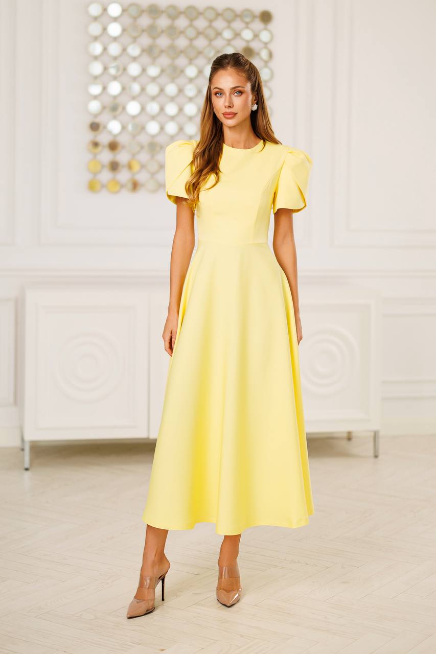 Woman wearing a yellow dress in an indoor setting