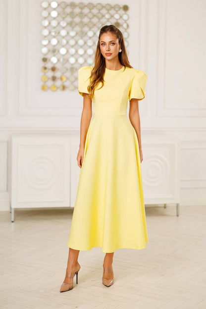 Woman wearing a yellow dress in an indoor setting