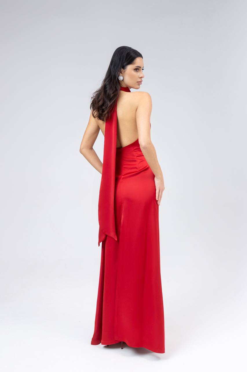 Woman wearing a red dress with a halter neck design on a white background
