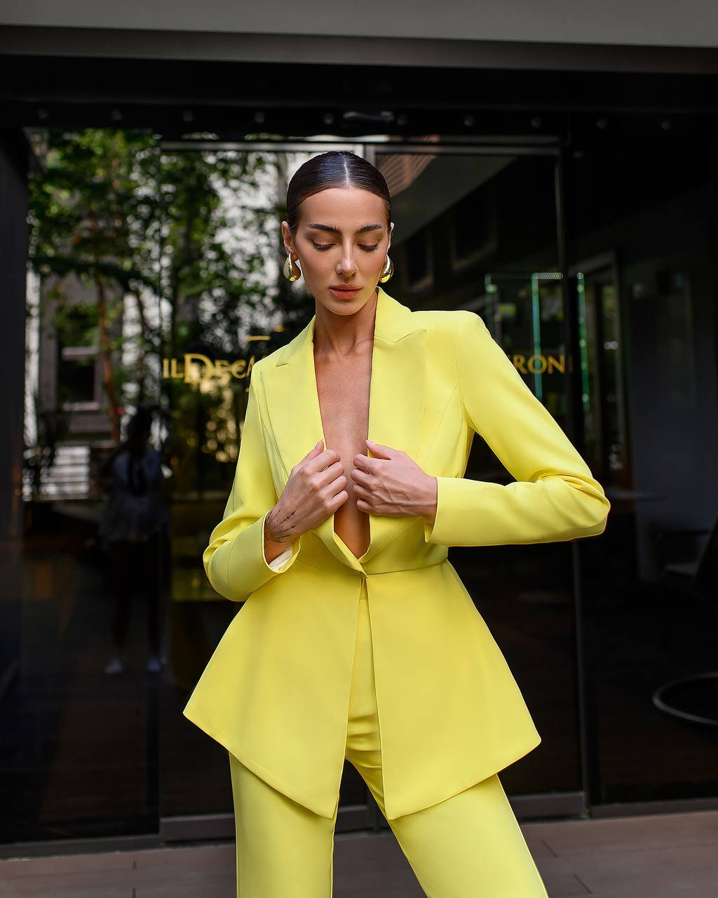 Woman wearing a bright yellow suit in an outdoor setting