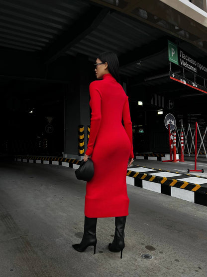 Person wearing a red coat walking in an urban setting