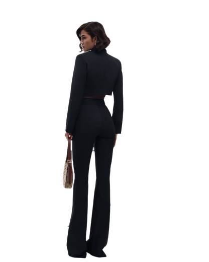 Woman wearing a black suit with a white background