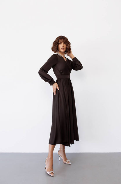 Woman wearing a black dress against a white background