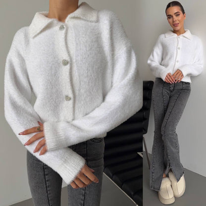 White cardigan worn by a person with a neutral background