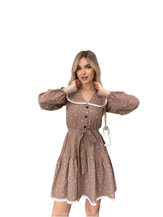 Woman wearing a brown patterned dress with a white collar on a white background