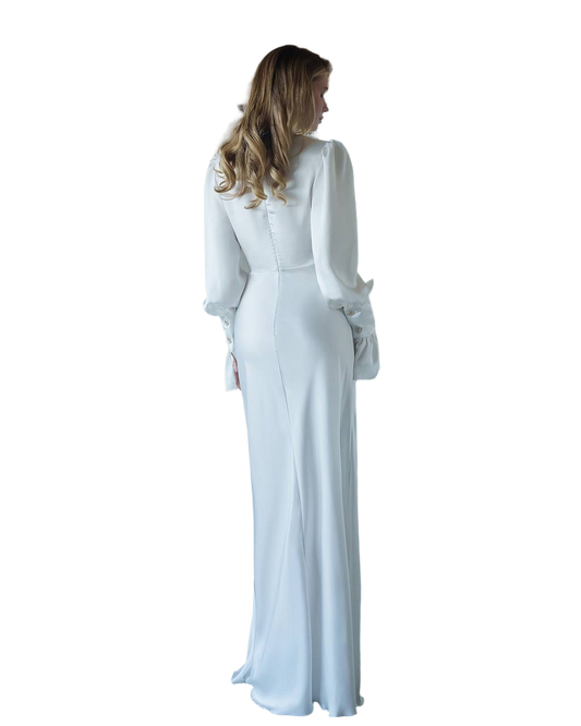 Woman wearing a white long-sleeve dress on a white background