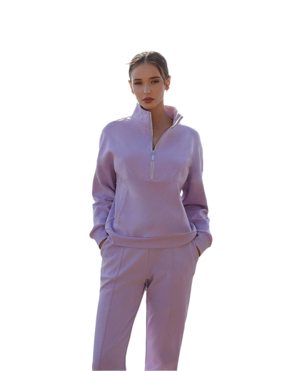 Woman wearing a lavender tracksuit on a white background