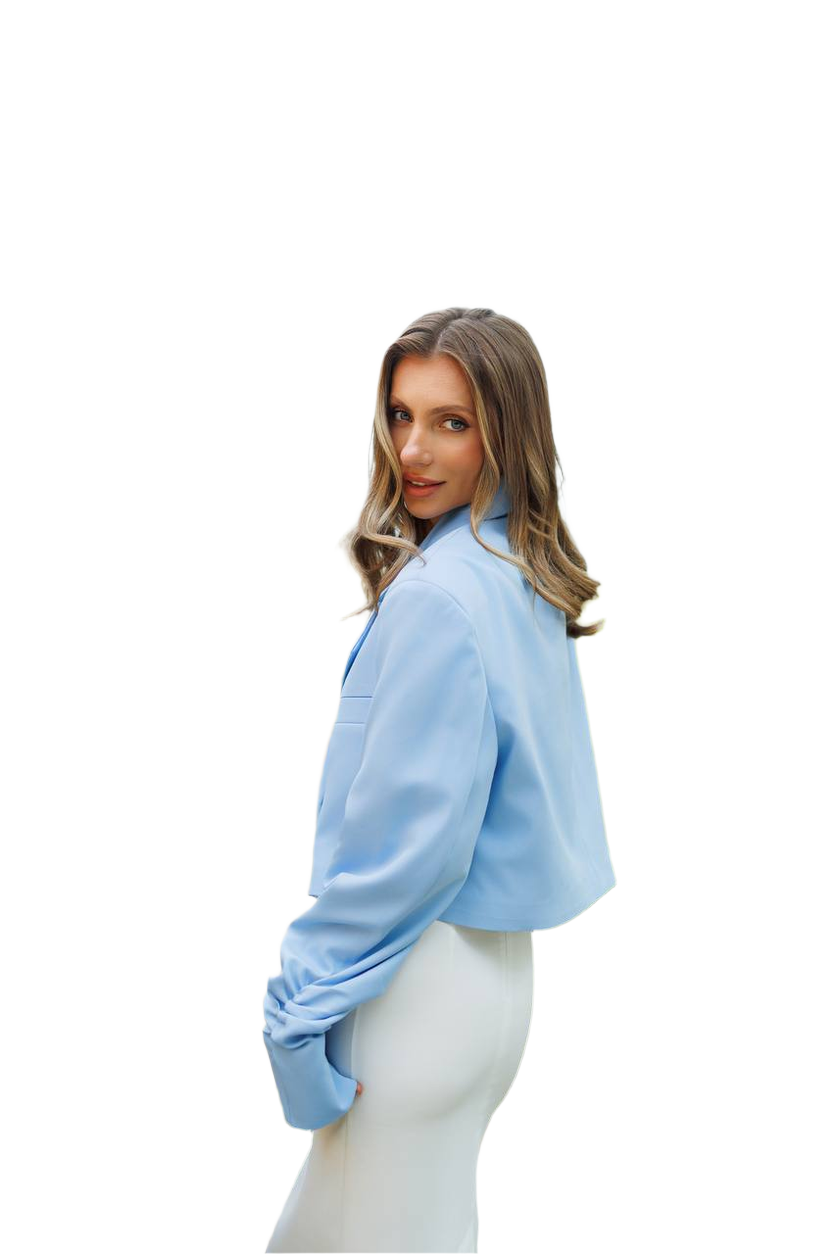 Woman wearing a light blue blouse and white pants on a white background