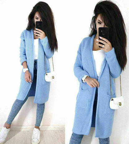 Woman wearing a light blue cardigan in front of a white background