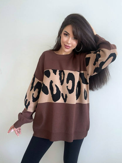 Woman wearing a brown sweater with a leopard print design against a white background