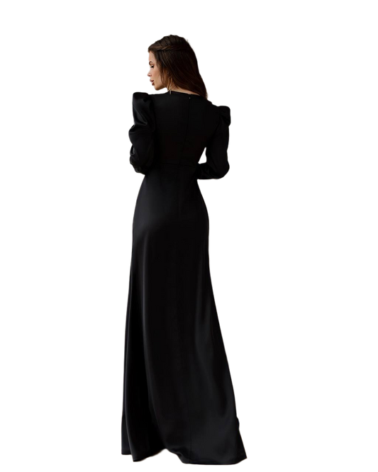 Woman wearing a black evening gown with ruffled sleeves on a white background