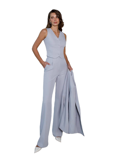 Woman wearing a light gray jumpsuit on a white background