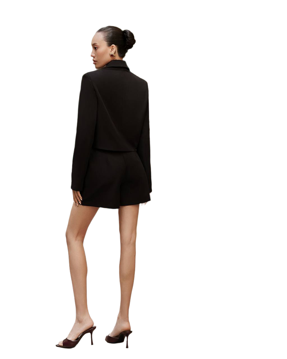 Woman wearing a black suit on a white background