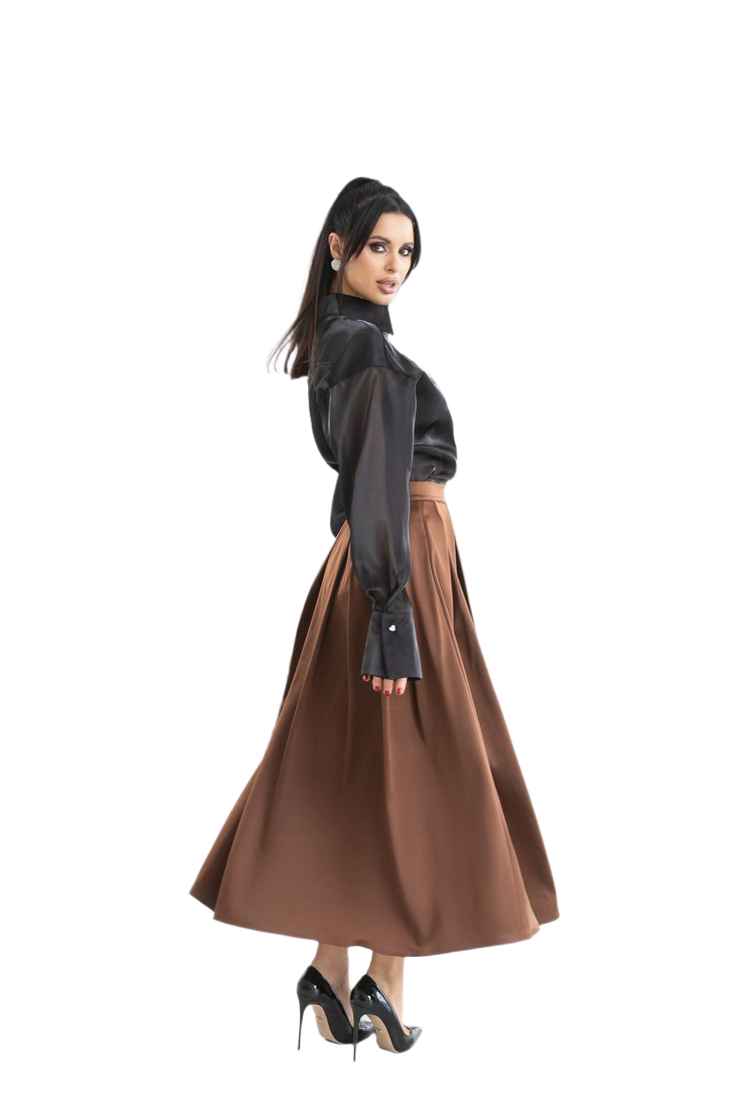 Woman wearing a black blouse and brown skirt on a white background