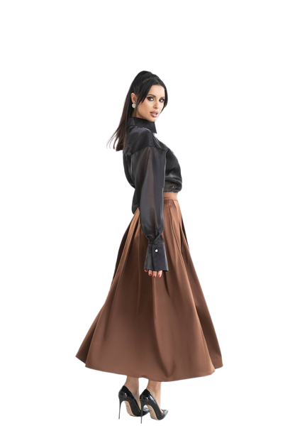 Woman wearing a black blouse and brown skirt on a white background