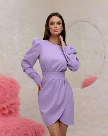Woman wearing a purple dress against a soft pink background