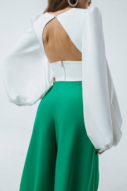 White blouse with cut-out design and green pants on a white background