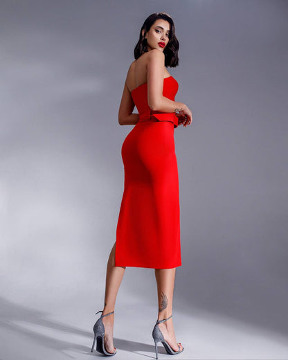 Woman wearing a red dress on a gray background