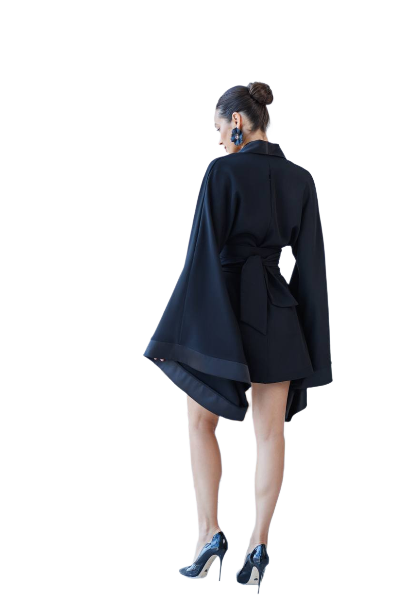 Person wearing a black coat with a white background