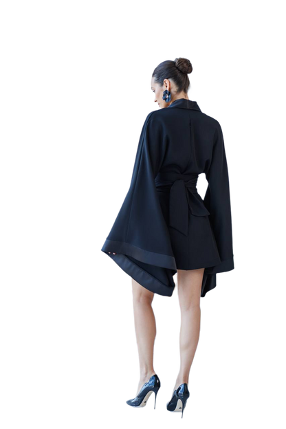 Person wearing a black coat with a white background