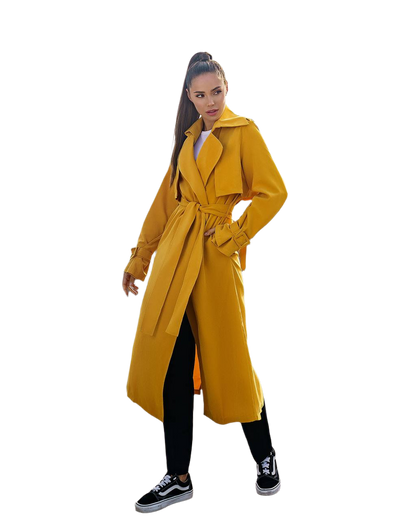 Woman wearing a yellow trench coat on a white background