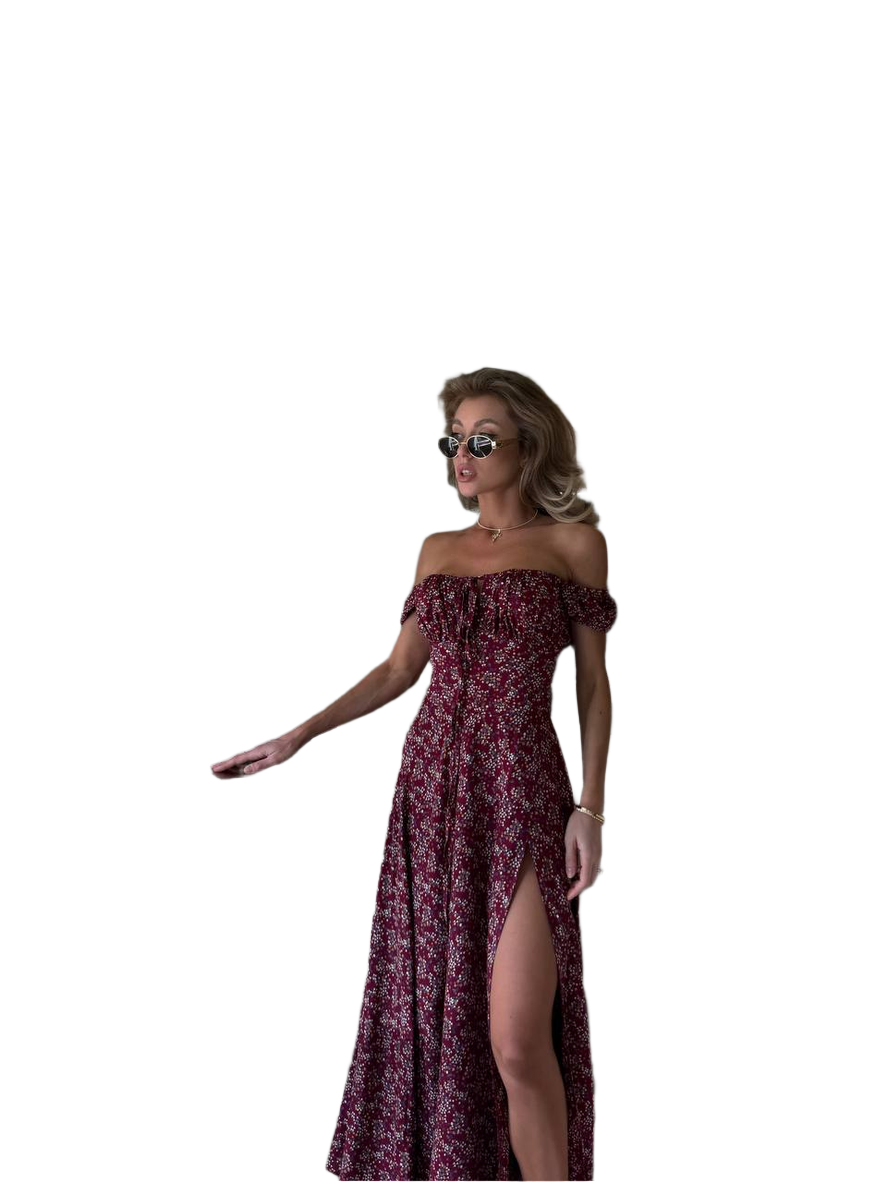 Woman wearing a burgundy off-shoulder dress with a slit on a white background