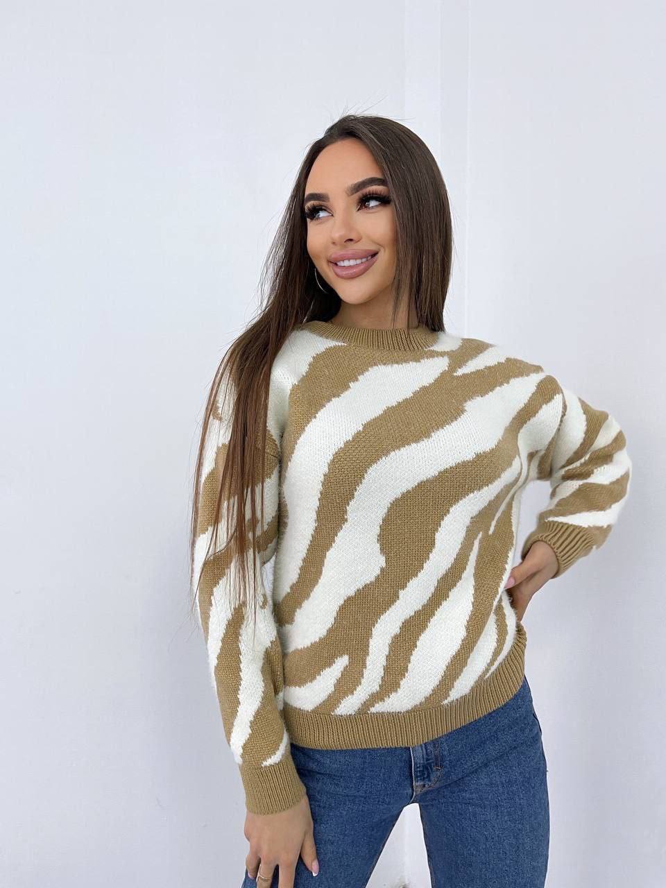Woman wearing a zebra print sweater against a white background