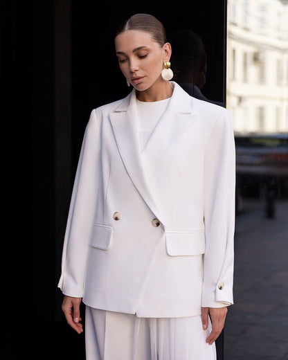 Woman wearing a white suit with a blurred background