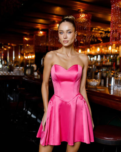 Woman in a pink dress standing in a bar setting