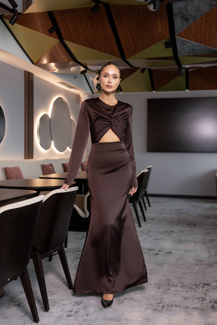 Woman in a brown outfit standing in a modern restaurant setting