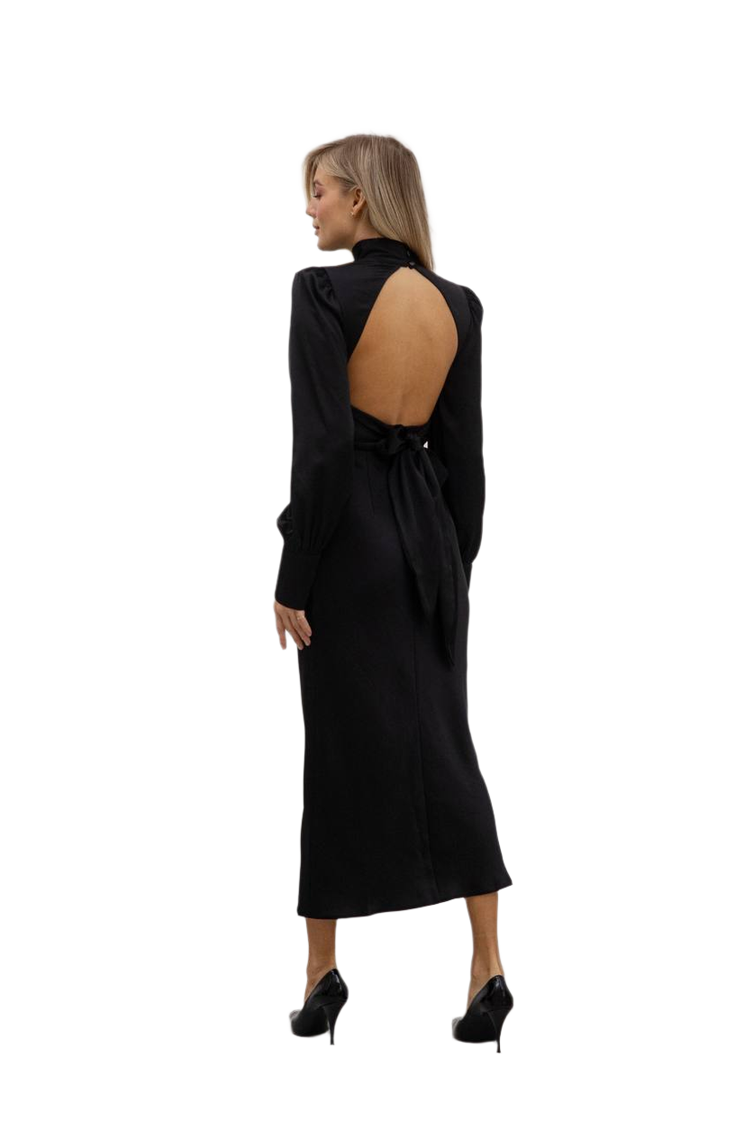 Black dress with cut-out back worn by a model on a white background