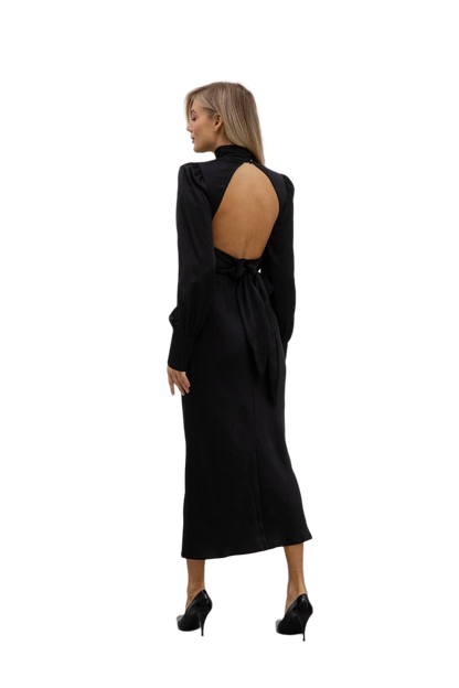 Black dress with cut-out back worn by a model on a white background