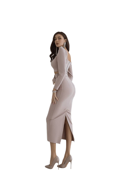 Woman wearing a light pink dress with cut-out shoulders on a white background