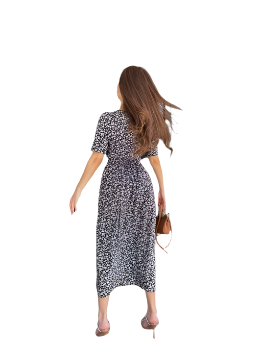 Woman wearing a black and white floral dress on a white background