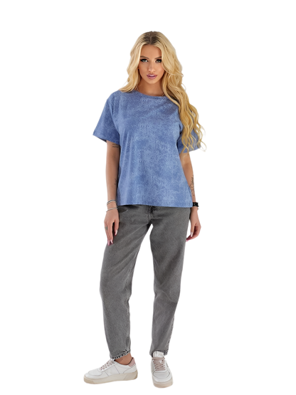 Woman wearing a blue t-shirt and gray pants on a white background