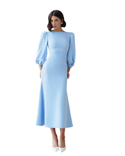 Woman wearing a light blue dress with puff sleeves on a white background