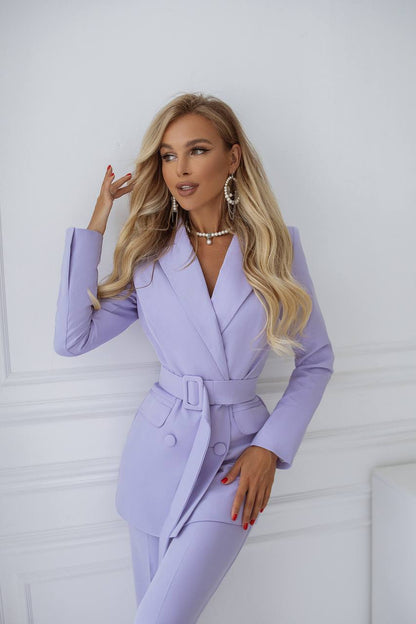 Woman wearing a lavender suit against a white background