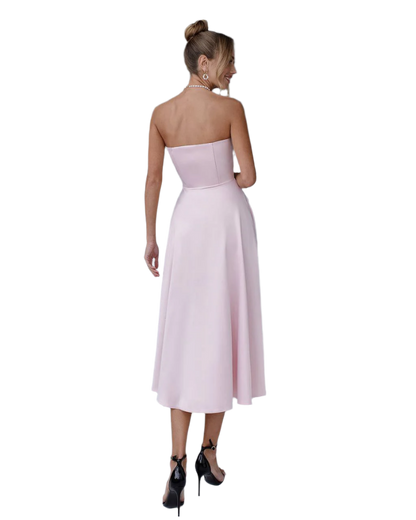 Woman wearing a strapless pink dress on a white background