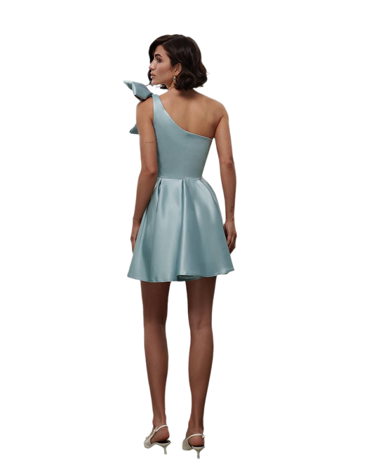 Woman wearing a light blue one-shoulder dress on a white background