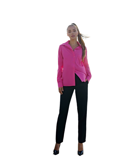 Woman wearing a bright pink blouse and black pants on a white background