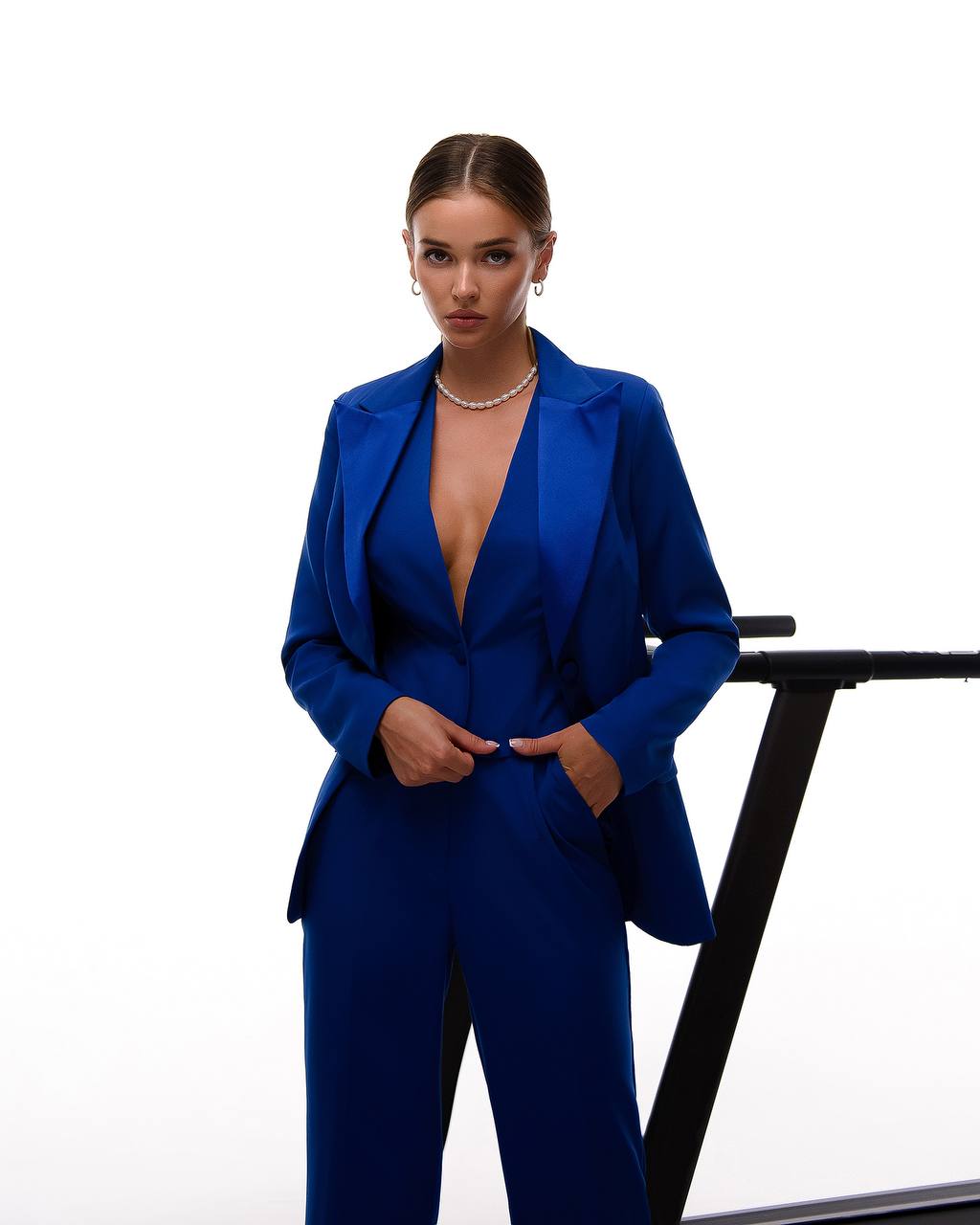 Woman wearing a blue suit with a white background