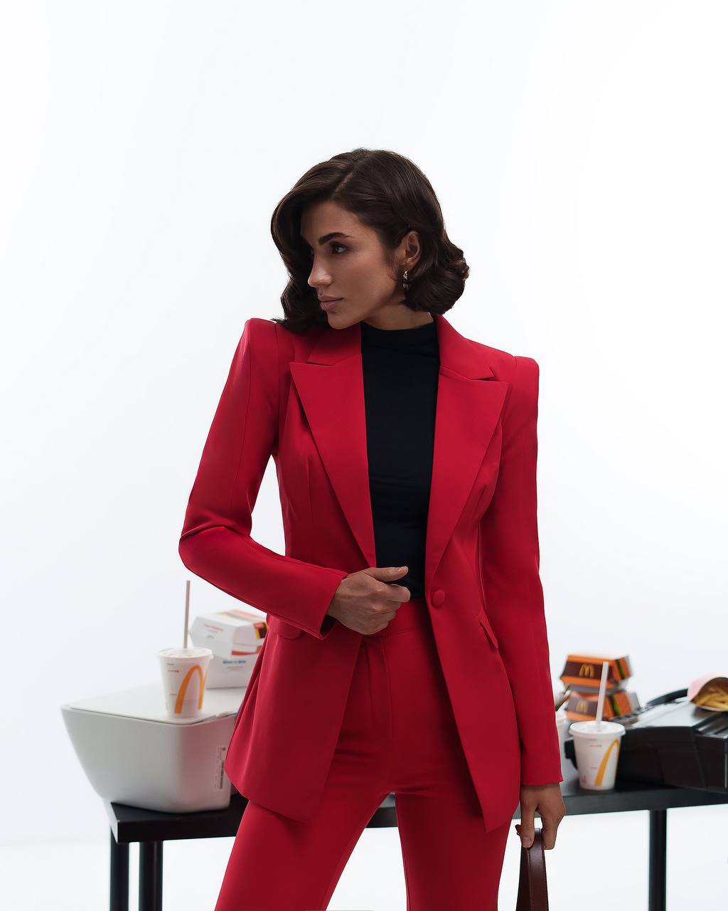 Woman wearing a red suit with a blurred background