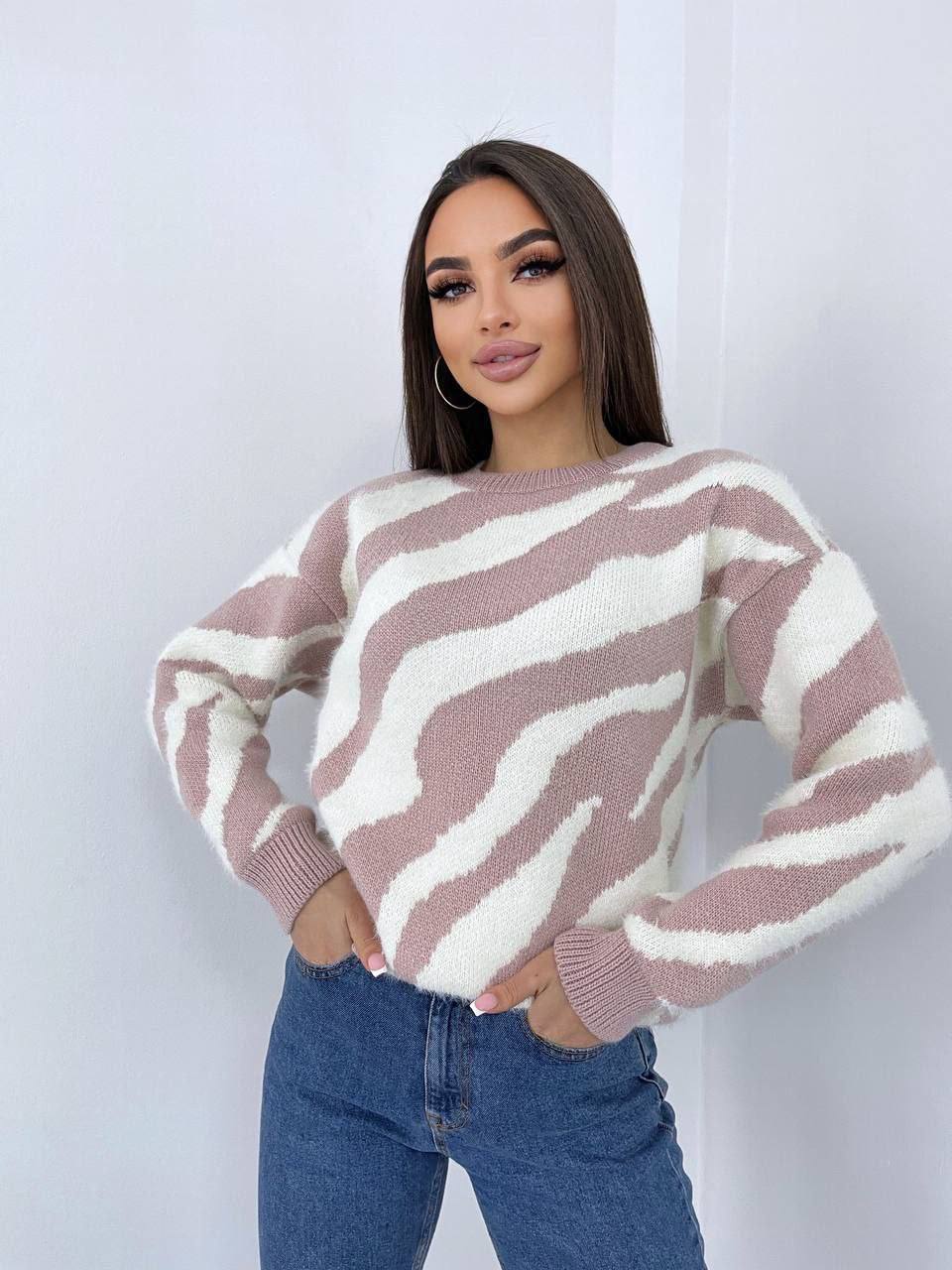 Woman wearing a zebra-striped sweater against a white background