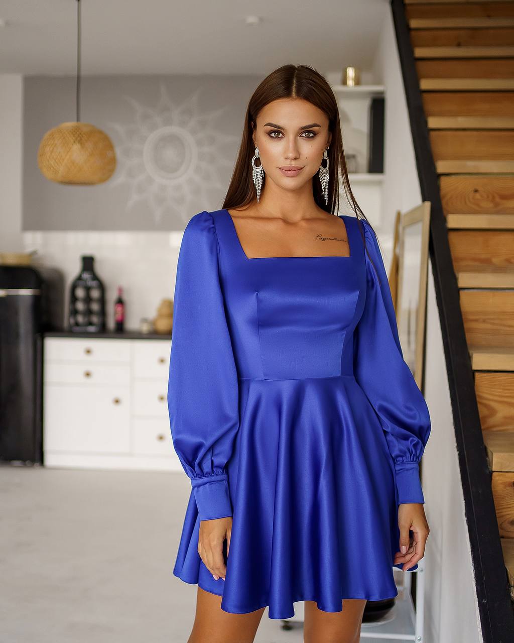 Woman wearing a blue dress in an indoor setting