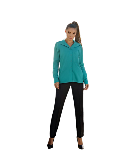 Woman wearing a teal jacket and black pants on a white background