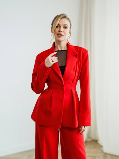 Woman wearing a red suit against a white background