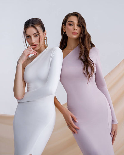 Two women wearing elegant dresses against a neutral background