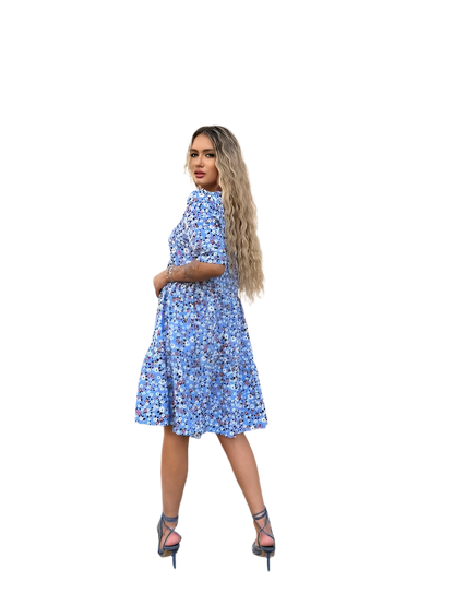 Woman wearing a blue floral dress on a white background
