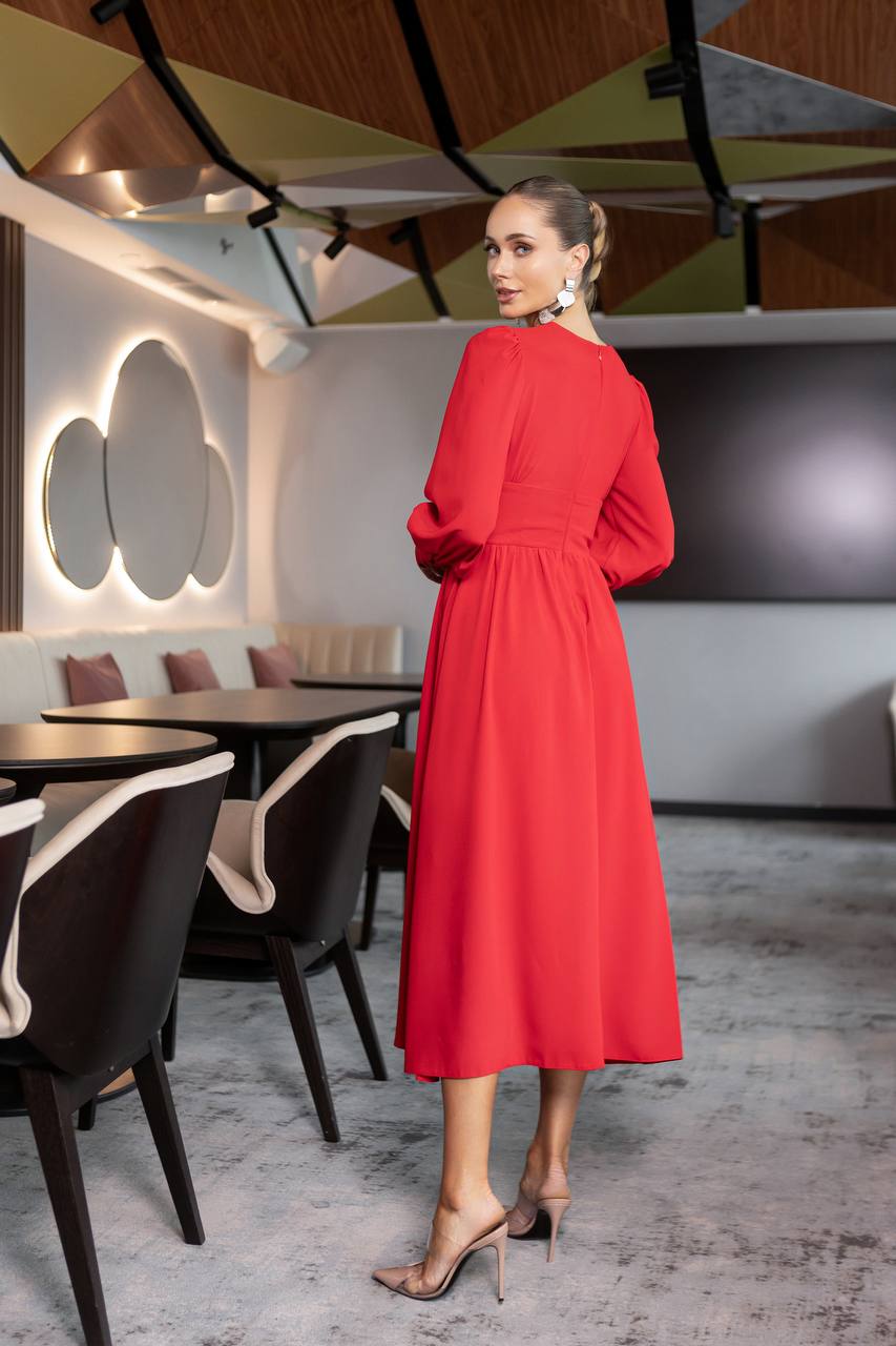 Woman in a red dress standing in a modern restaurant setting